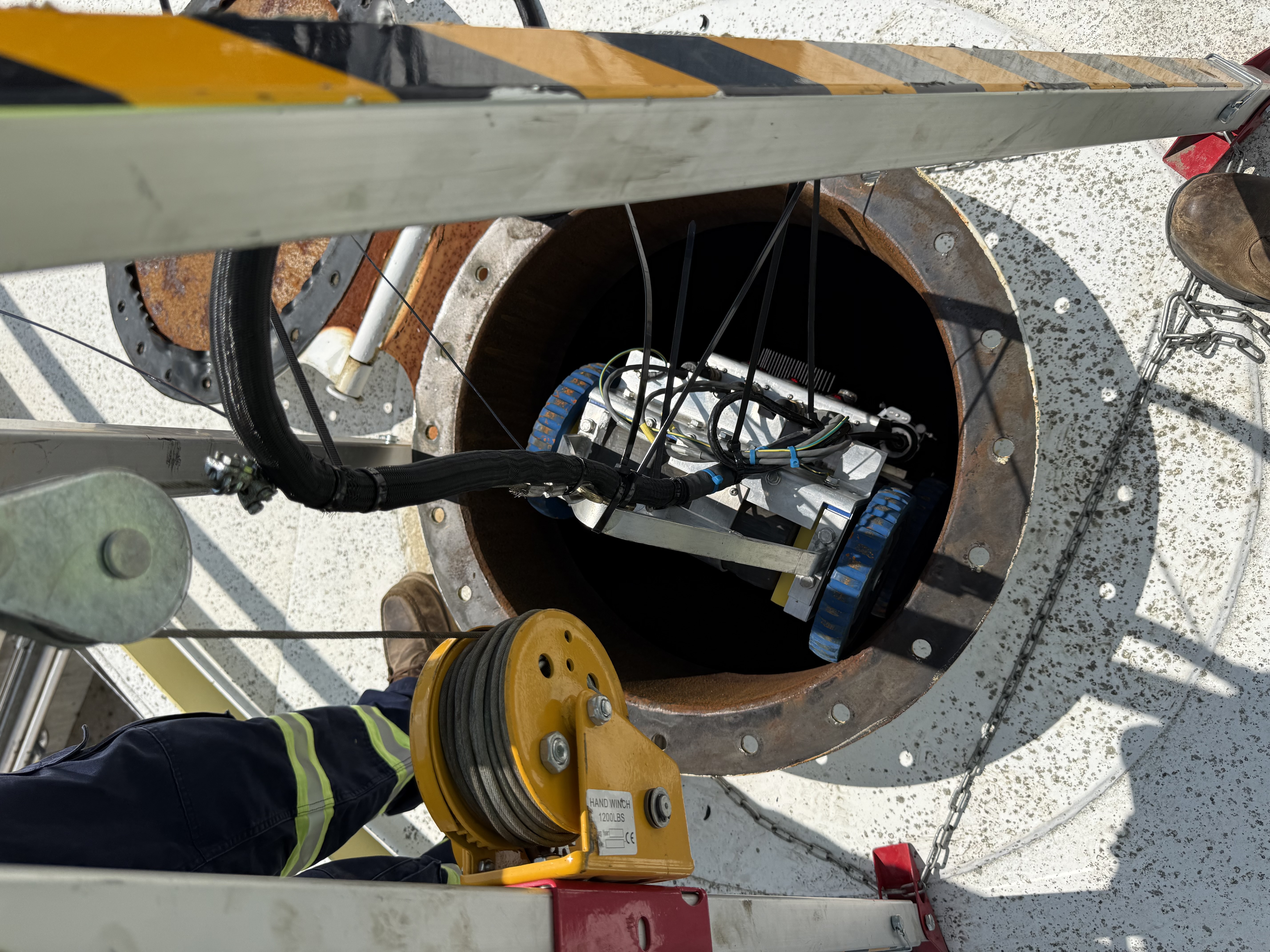 BSI Scavenger 3.0 in-service robotic tank scanner, top-down view being lowered into a manway