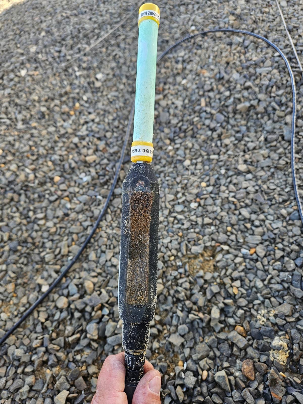 The Smart Tank ultrasonic probe, held in hand at a field site